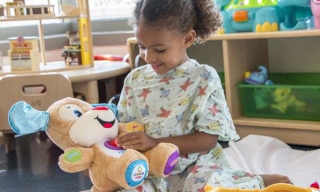 Child playing with stuffed animal